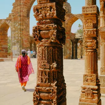 This is a photo of Qutub Minar, showing the intricate engraving and carvings done. The photo instills a sense of strength and poise.