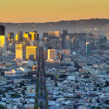 Aerial of Market Street in downtown San Francisco, as seen from Twin Peaks.
581043009
Urban Skyline, Busy, Twin Peaks - San Francisco, Downtown District, Sunrise - Dawn, Fog, Travel Destinations, Horizontal, Tourism, Building Exterior, San Francisco - California, San Francisco, San Francisco-Oakland Bay Bridge, Outdoors, High Angle View, Day, Market Street - San Francisco, Photography, Scenics - Nature, Color Image, Horizon Over Land, Hill, No People, Cityscape, Architecture, Famous Place, International Landmark, USA, California, Skyline, Sunlight