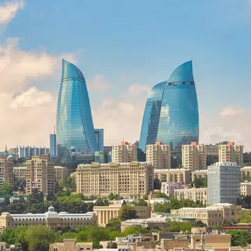 The iconic Flame Towers, stand tall against a vibrant sunset sky. These modern skyscrapers are a symbol of the citys dynamic growth and futuristic vision