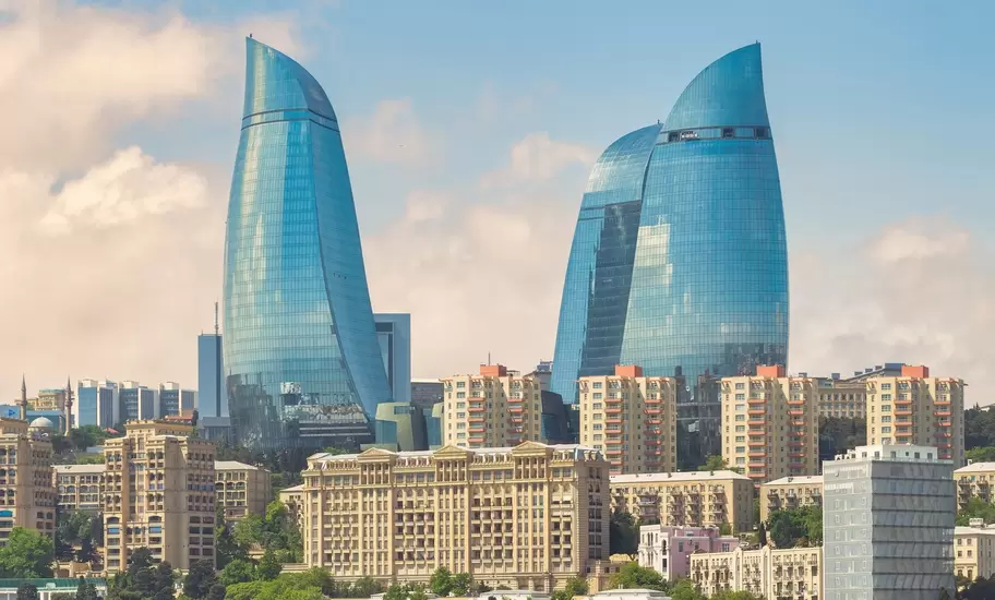 The iconic Flame Towers, stand tall against a vibrant sunset sky. These modern skyscrapers are a symbol of the citys dynamic growth and futuristic vision