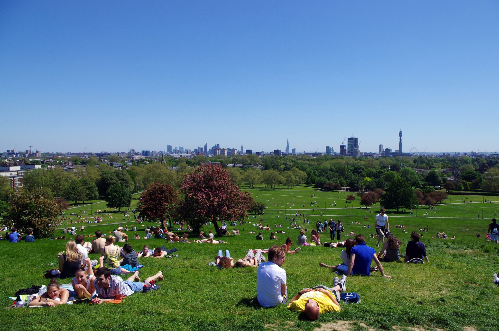 People lay on the grass at Primrose Hill in Regent's Park, with the skyline of central London on the horizon.
569077953
Primrose Hill, Grass, Capital Cities, Sitting, Human Interest, London, Friendship, UK, Sunlight, Day, London - England, Sky, View, Blue, Horizontal, Photography, Sunbathing, Outdoors, People, Tree, Built Structure, Blossom, Color Image, Summer, Urban Skyline, Lawn, Relaxation, England