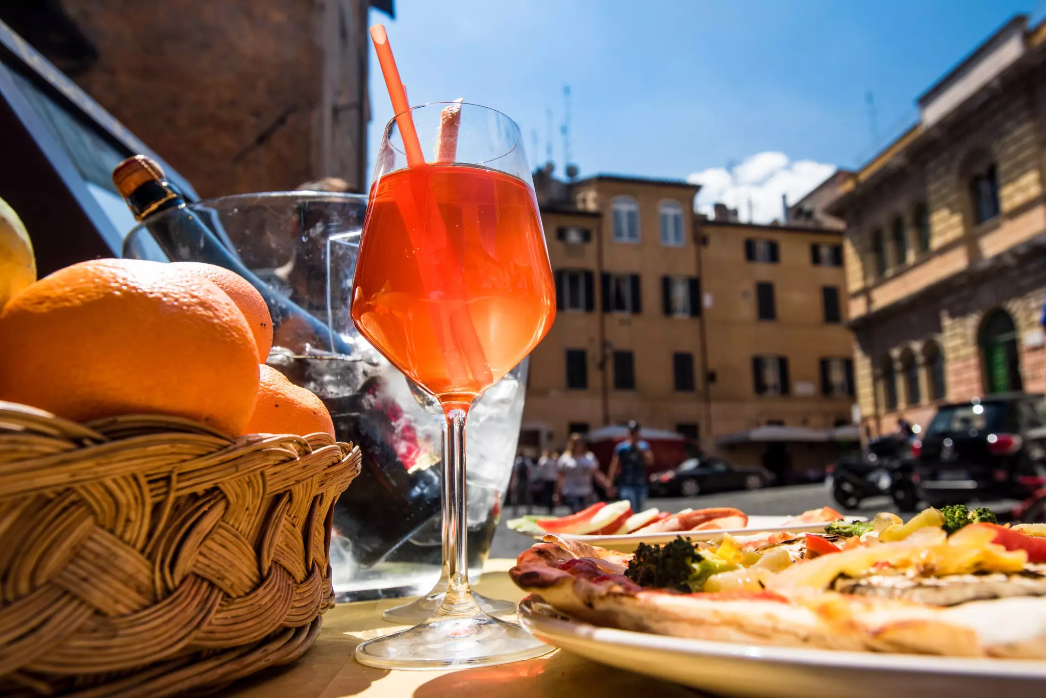 Aperol spritz cocktail and Italian pizza on Piazza di Santa Maria in Trastevere