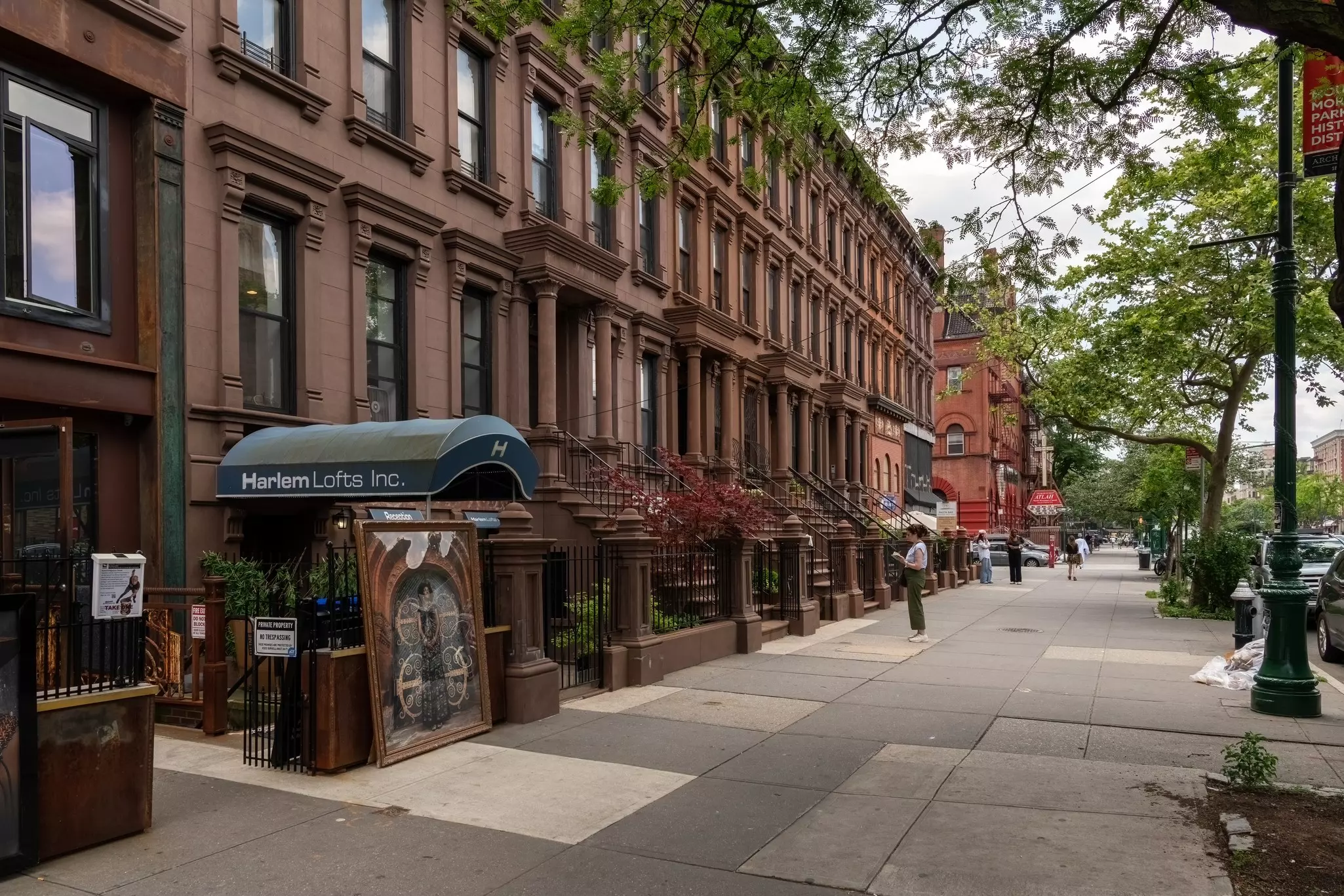 A street of brownstone buildings in Harlem. 