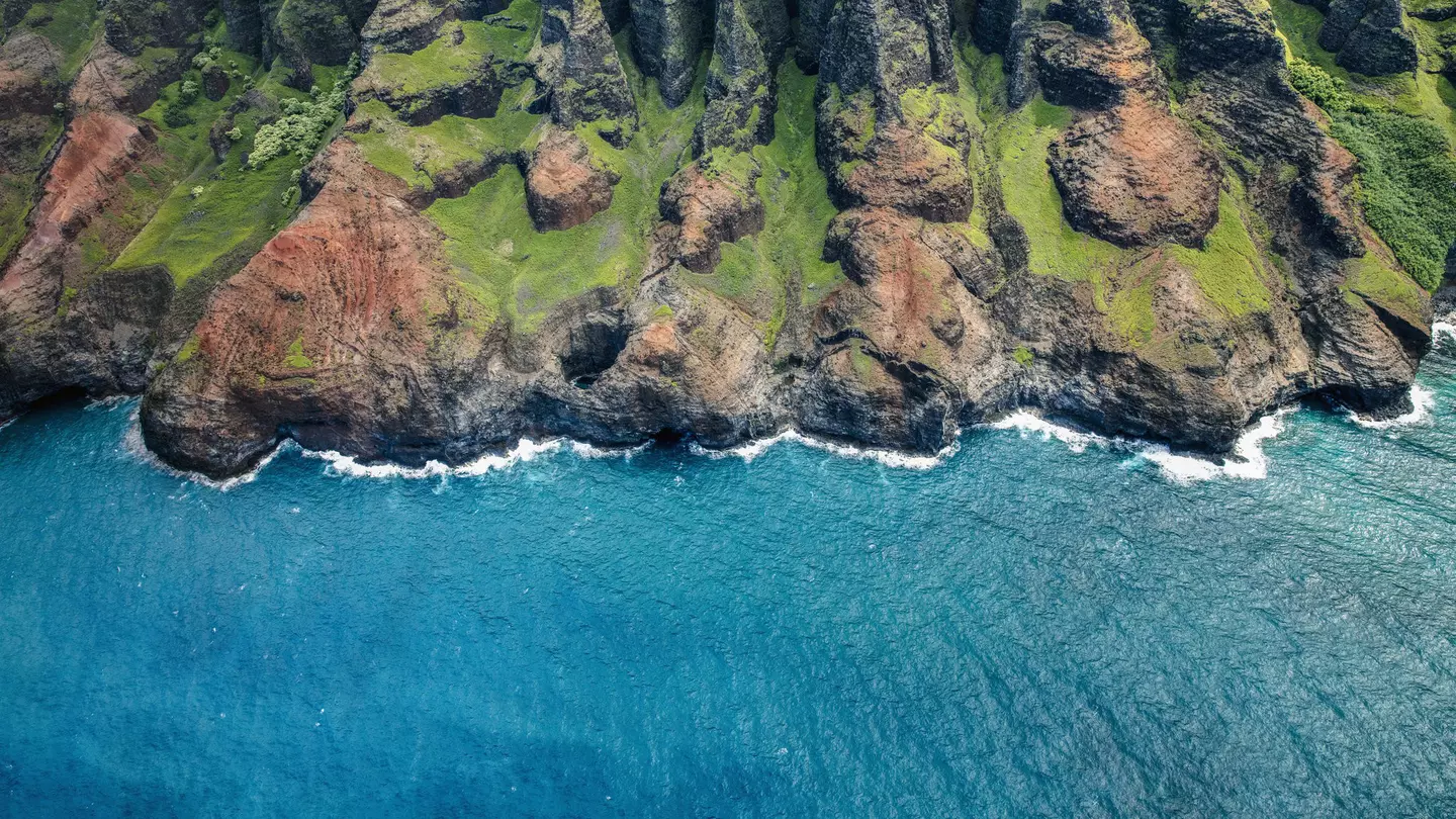 The rugged coast of Kauai as seen from a helicopter above