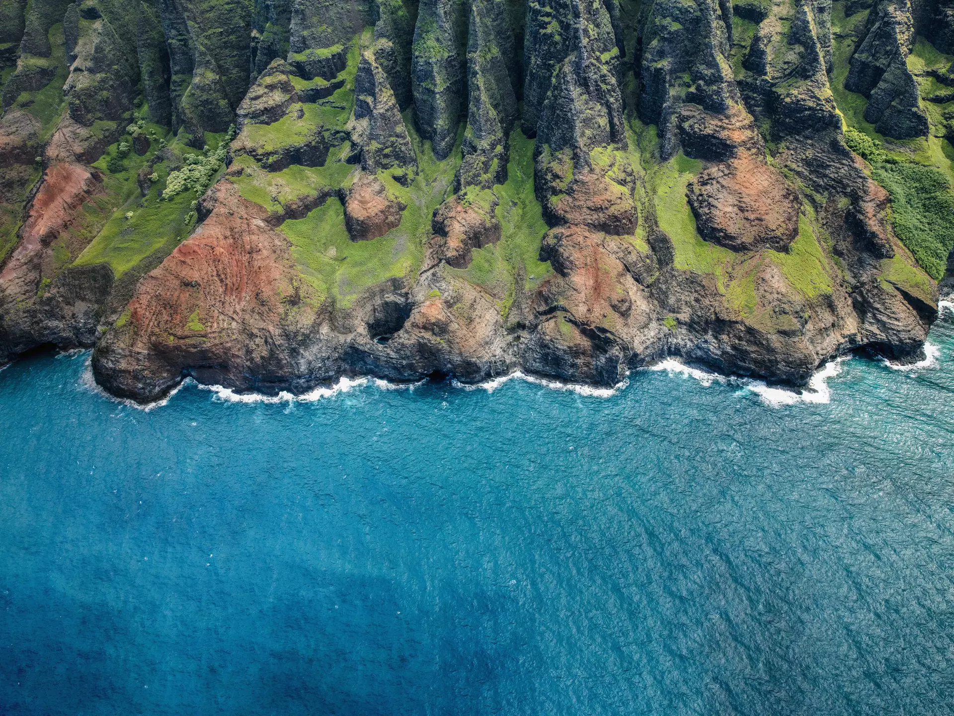 The rugged coast of Kauai as seen from a helicopter above