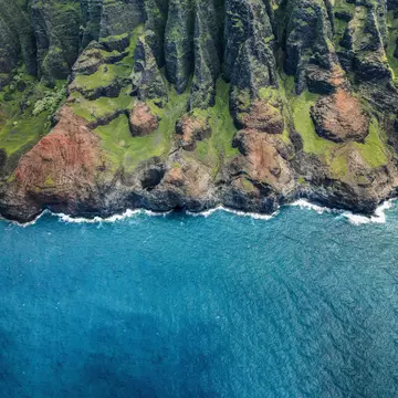 The rugged coast of Kauai as seen from a helicopter above