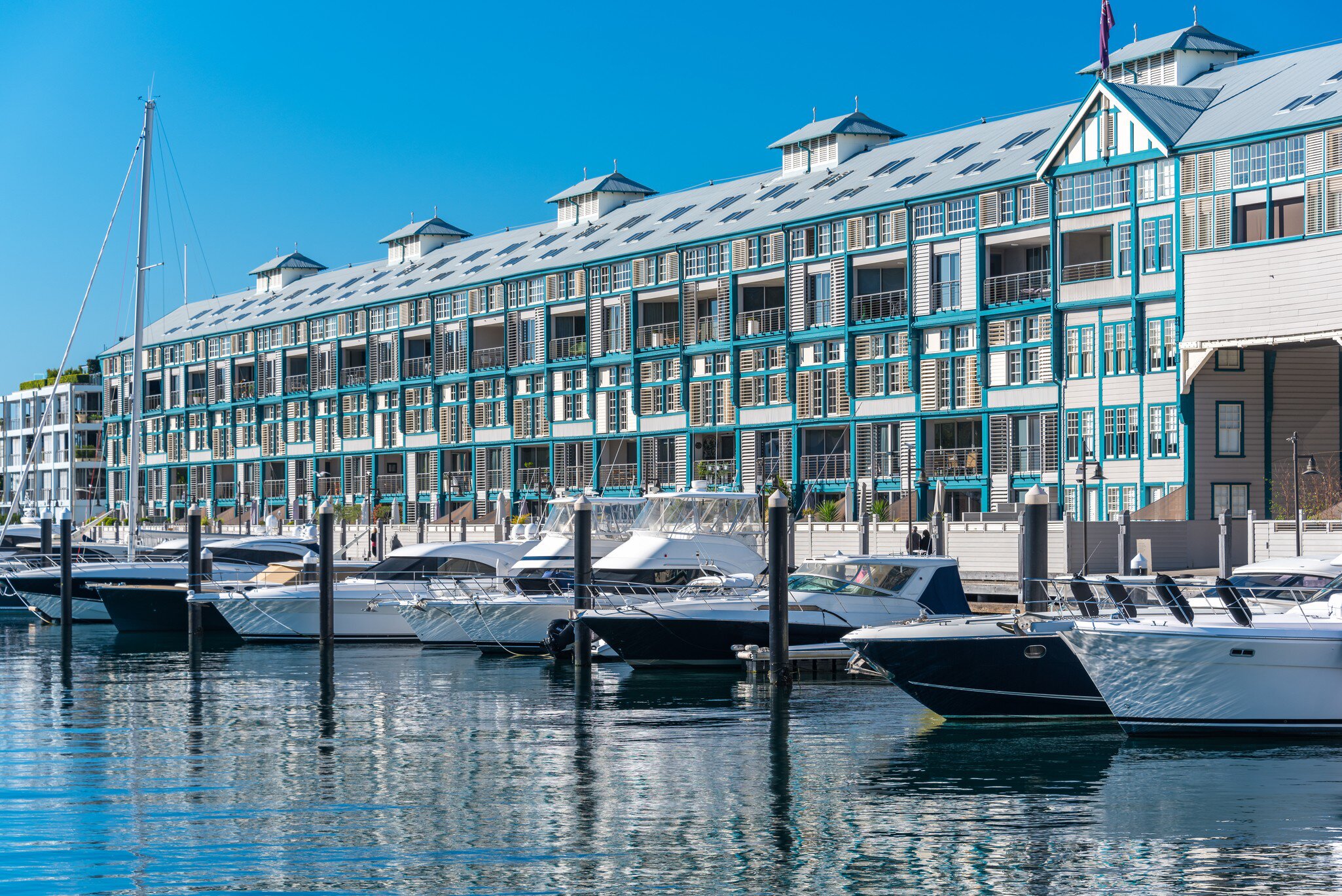 Historic landmark Woolloomooloo wharf with yachts and boats on sunny day. Sydney, Australia.