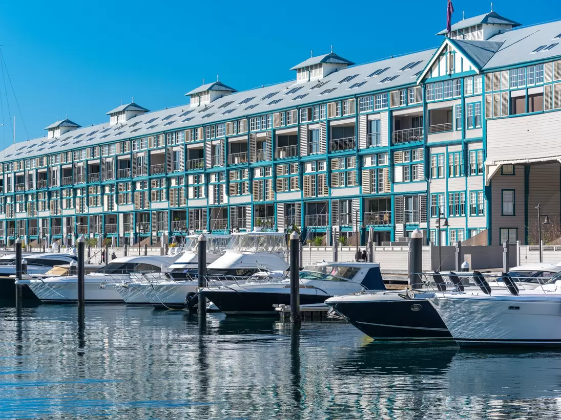 Historic landmark Woolloomooloo wharf with yachts and boats on sunny day. Sydney, Australia.