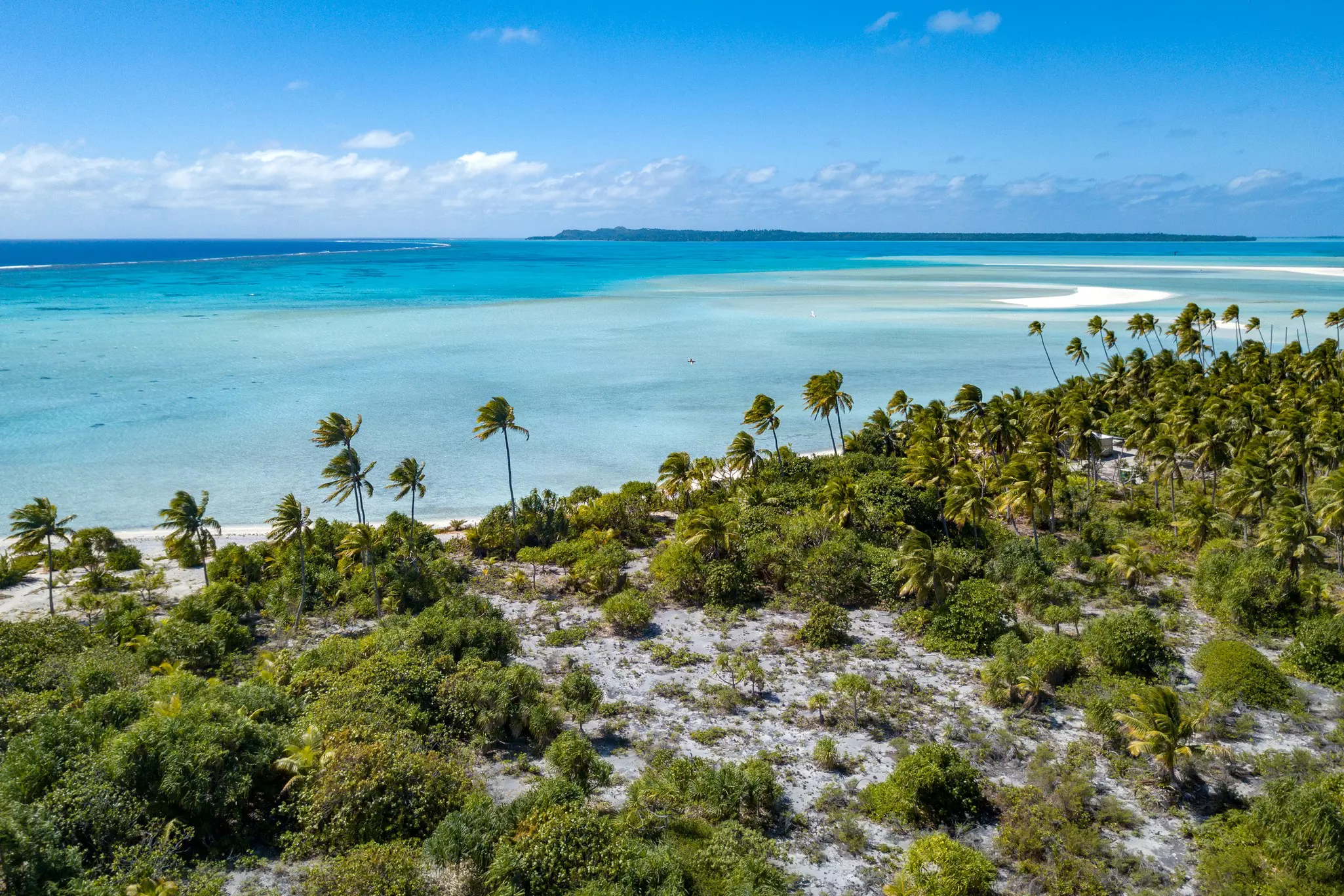 Aitutaki lagoon with surrounding greenery and sky