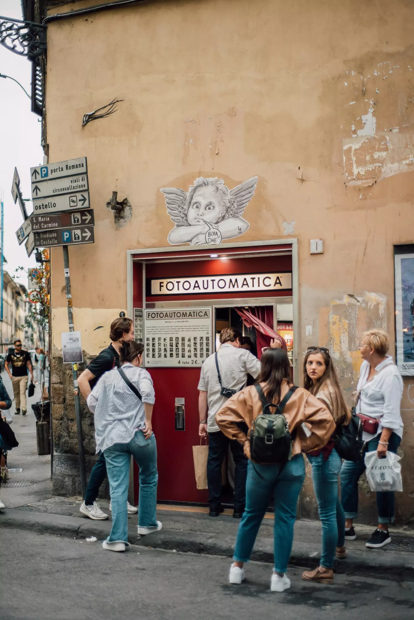 Famous Fotoautomatica, photobooth with people queuing in Florence. A mini dark-room and development studio within the machine