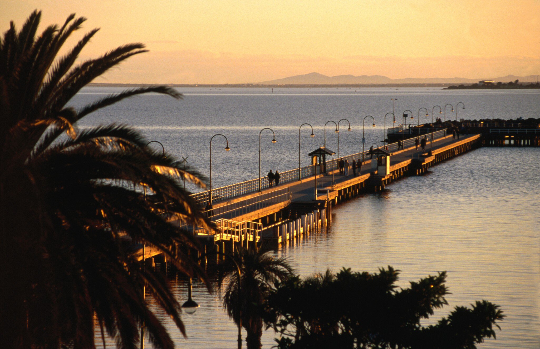 Wide angle view of St Kilda forshore pier at sunset. Melbourne, Australia.