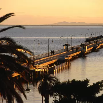 Wide angle view of St Kilda forshore pier at sunset. Melbourne, Australia.