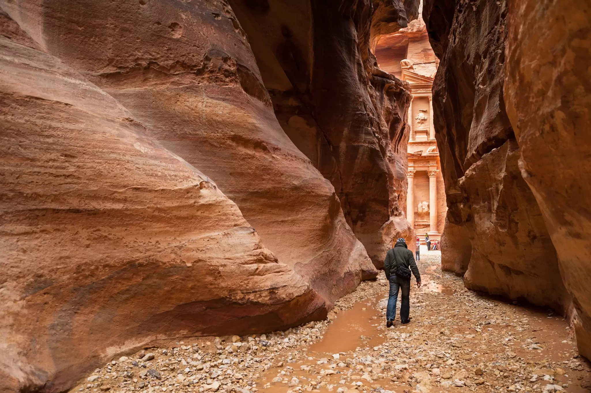 Start your day with the sunrise to get an early view of Petra's Treasury through the Siq. Yongyut Kumsri / Shutterstock