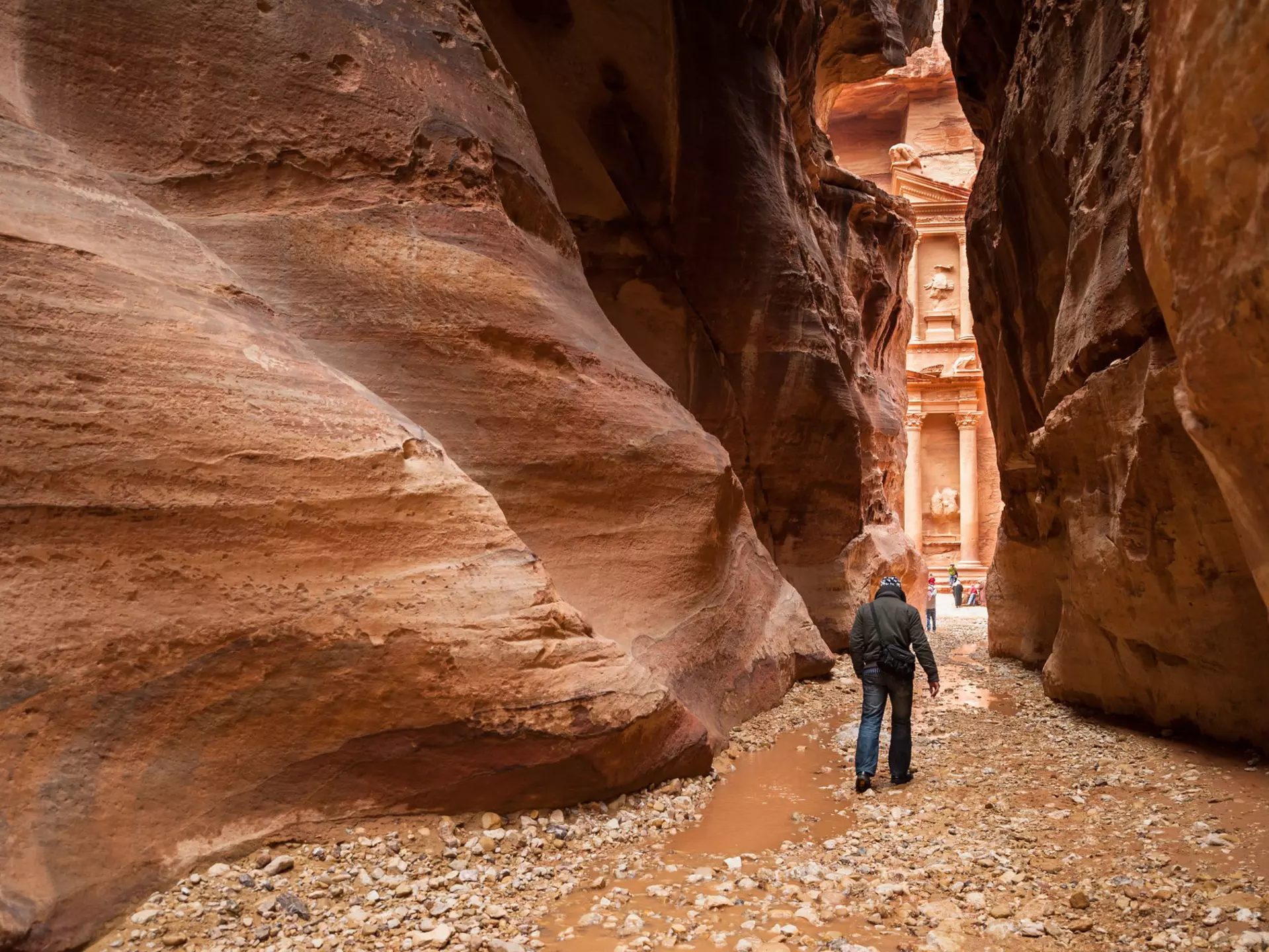 Start your day with the sunrise to get an early view of Petra's Treasury through the Siq. Yongyut Kumsri / Shutterstock