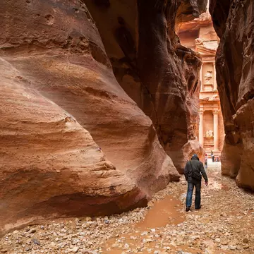 Start your day with the sunrise to get an early view of Petra's Treasury through the Siq. Yongyut Kumsri / Shutterstock
