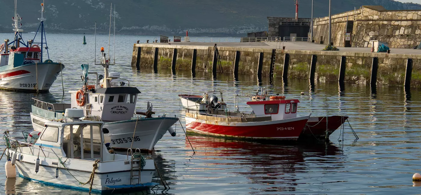 Percebeiros prepare to depart from the fishing town of Corme, on the Costa da Morte.