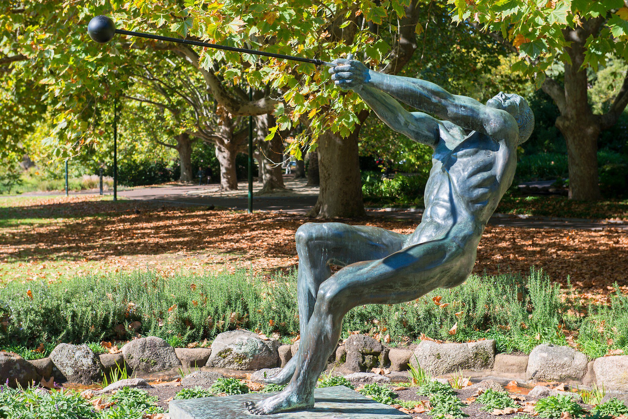 Bronze sculpture of hammer thrower in Queen Victoria Gardens, Melbourne, Australia.