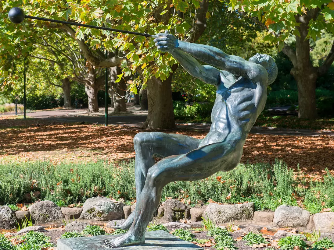 Bronze sculpture of hammer thrower in Queen Victoria Gardens, Melbourne, Australia.