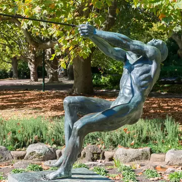 Bronze sculpture of hammer thrower in Queen Victoria Gardens, Melbourne, Australia.