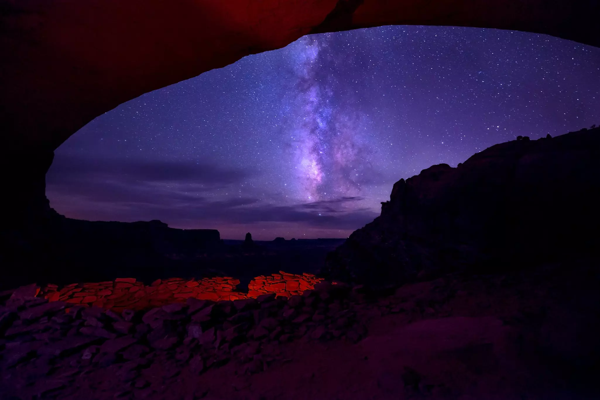 Nighttime shot of the Milky Way from inside a canyon overhand, Canyonlands National Park, Utah.