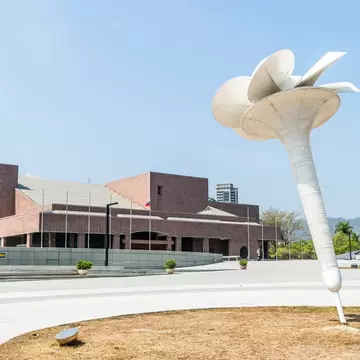 White flower sculpture in front of the brick building of the Kaohsiung Museum of Fine Arts in Kaohsiung, Taiwan.