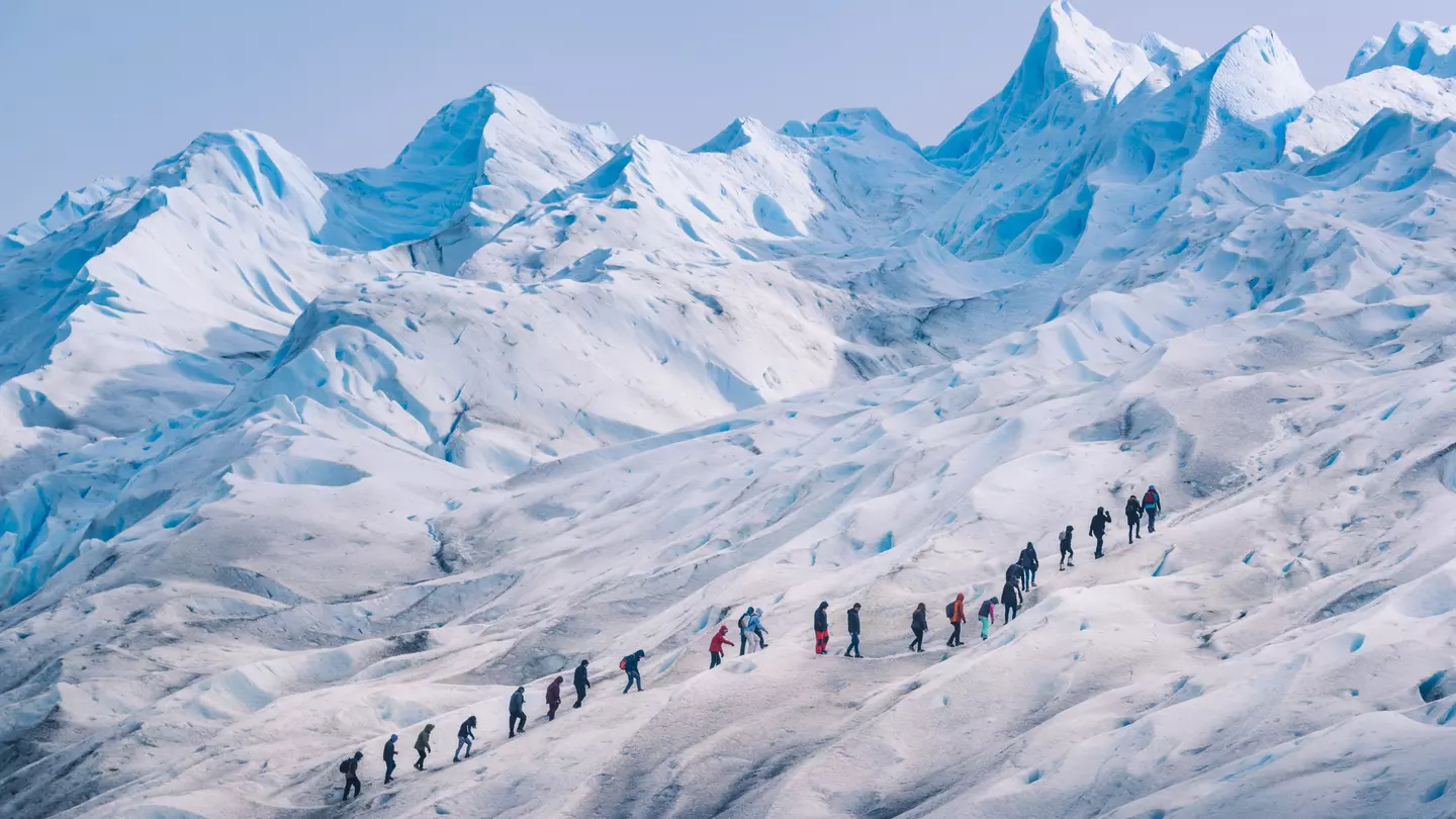 People hiking in a row on the ice of Perito Moreno glacier, Los Glaciares National Park