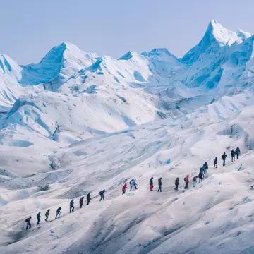 People hiking in a row on the ice of Perito Moreno glacier, Los Glaciares National Park