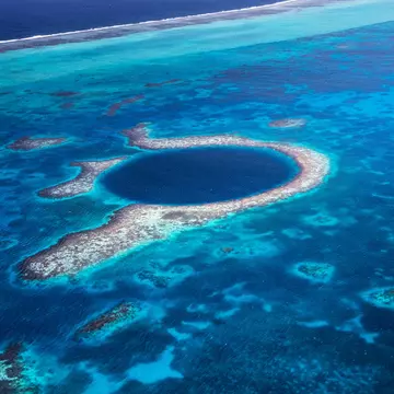 Aerial view down to the famous diving site and natural phenomenon the Blue Hole in the Lighthouse Reef, East of the Turneffe Atoll in Caribbean Sea, Belize, Central America.
510247581
Aerial View, Atoll, Backgrounds, Belize, Blue, Blue Hole, Caribbean, Caribbean Sea, Circle, Copy Space, Coral, Coral Colored, Famous Place, Lighthouse Reef, Natural Landmark, Natural Phenomenon, Nature, Photography, Postcard, Recreational Pursuit, Reef, Relaxation, Scuba Diving, Sea, Seascape, Sinkhole, Snorkeling, The Cayes, Tourism, Travel, Travel Destinations, Tropical Climate, Underwater Diving, Vacations, Water