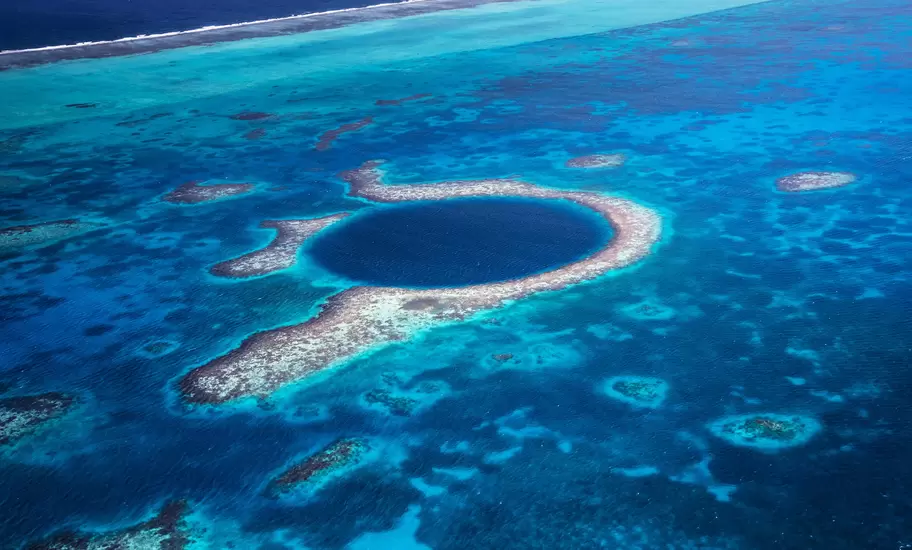 Aerial view down to the famous diving site and natural phenomenon the Blue Hole in the Lighthouse Reef, East of the Turneffe Atoll in Caribbean Sea, Belize, Central America.
510247581
Aerial View, Atoll, Backgrounds, Belize, Blue, Blue Hole, Caribbean, Caribbean Sea, Circle, Copy Space, Coral, Coral Colored, Famous Place, Lighthouse Reef, Natural Landmark, Natural Phenomenon, Nature, Photography, Postcard, Recreational Pursuit, Reef, Relaxation, Scuba Diving, Sea, Seascape, Sinkhole, Snorkeling, The Cayes, Tourism, Travel, Travel Destinations, Tropical Climate, Underwater Diving, Vacations, Water