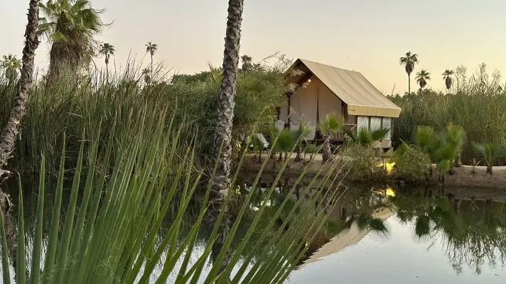 White sofa and dining tables in the common area. 