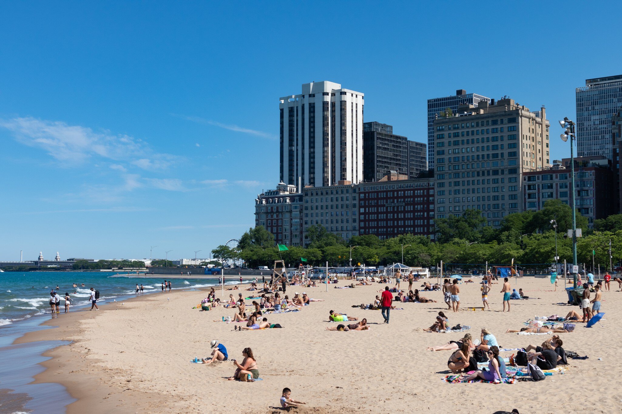 People relaxing on Oak Street Beach during the summer in Chicago, Illinois.