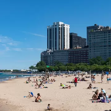 People relaxing on Oak Street Beach during the summer in Chicago, Illinois.