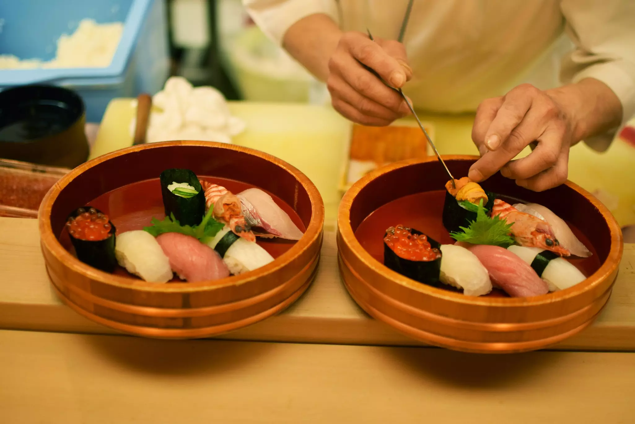 Handmade pieces of sushi inside a bamboo basket in a traditional Japanese restaurant in Kyoto