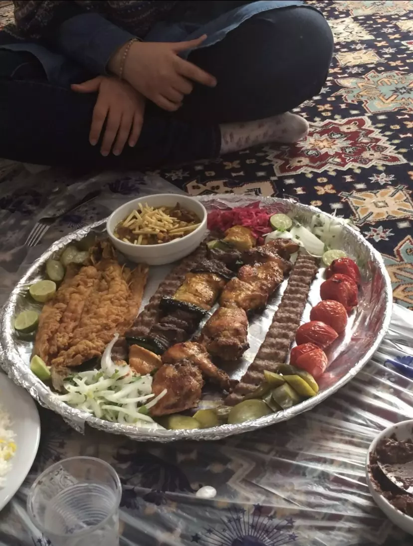 A plate of food on a cloth on the floor.