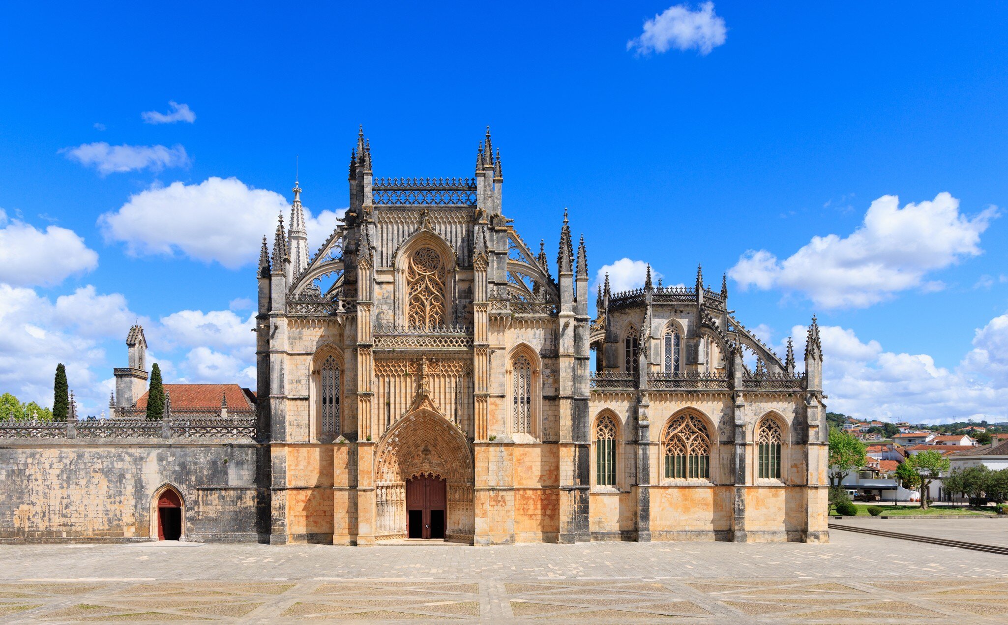 Exterior view of Mosteiro da Batalha on a sunny day in Portugal.