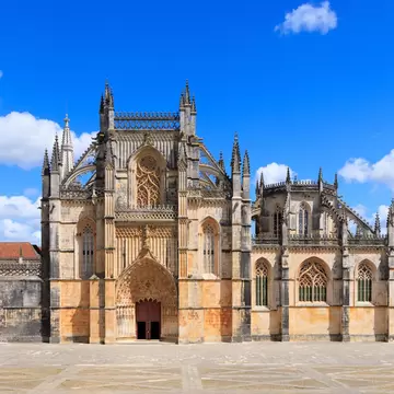 Exterior view of Mosteiro da Batalha on a sunny day in Portugal.