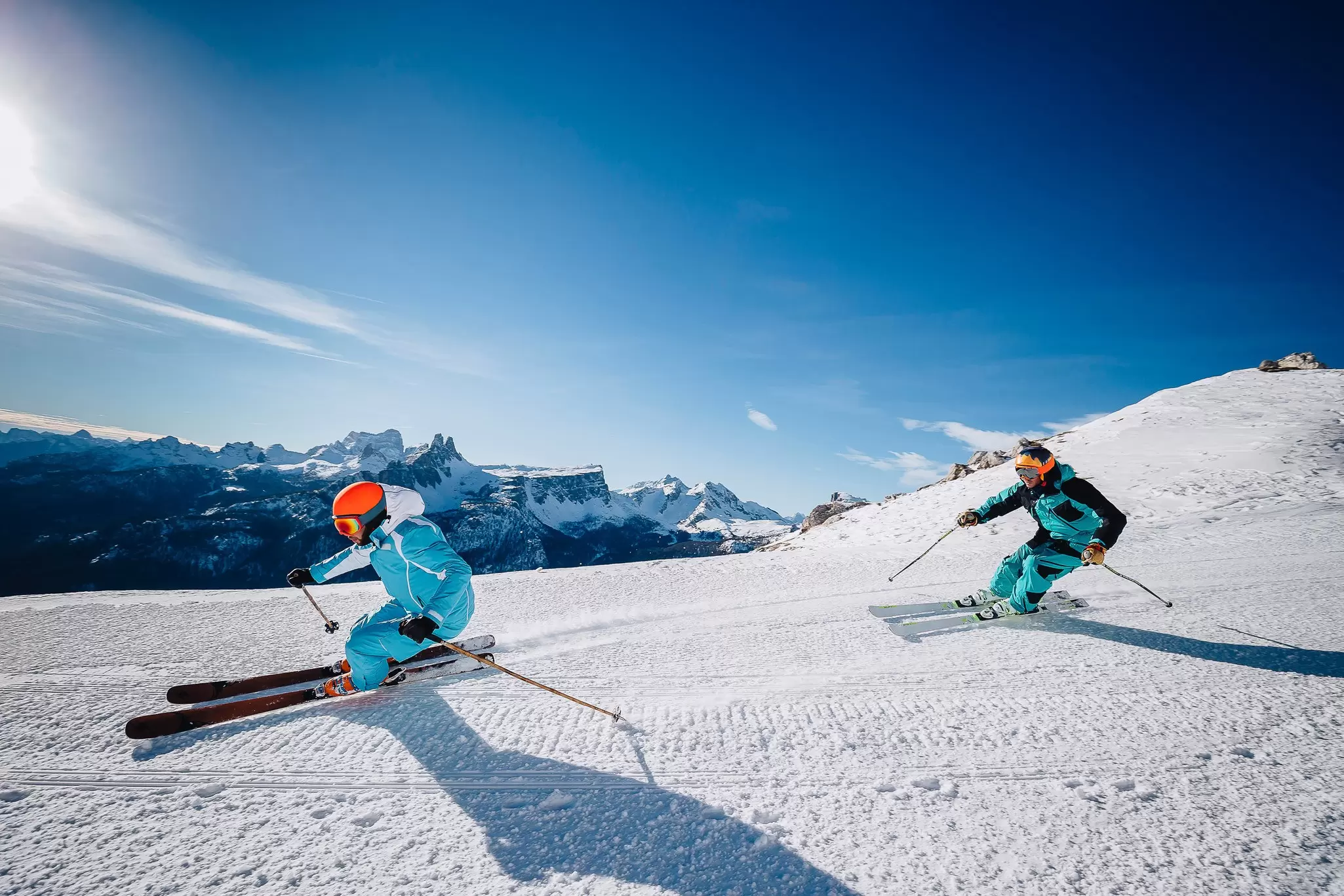 Two skiers on a piste in the Bellunesi Dolomites, Veneto, Italy.