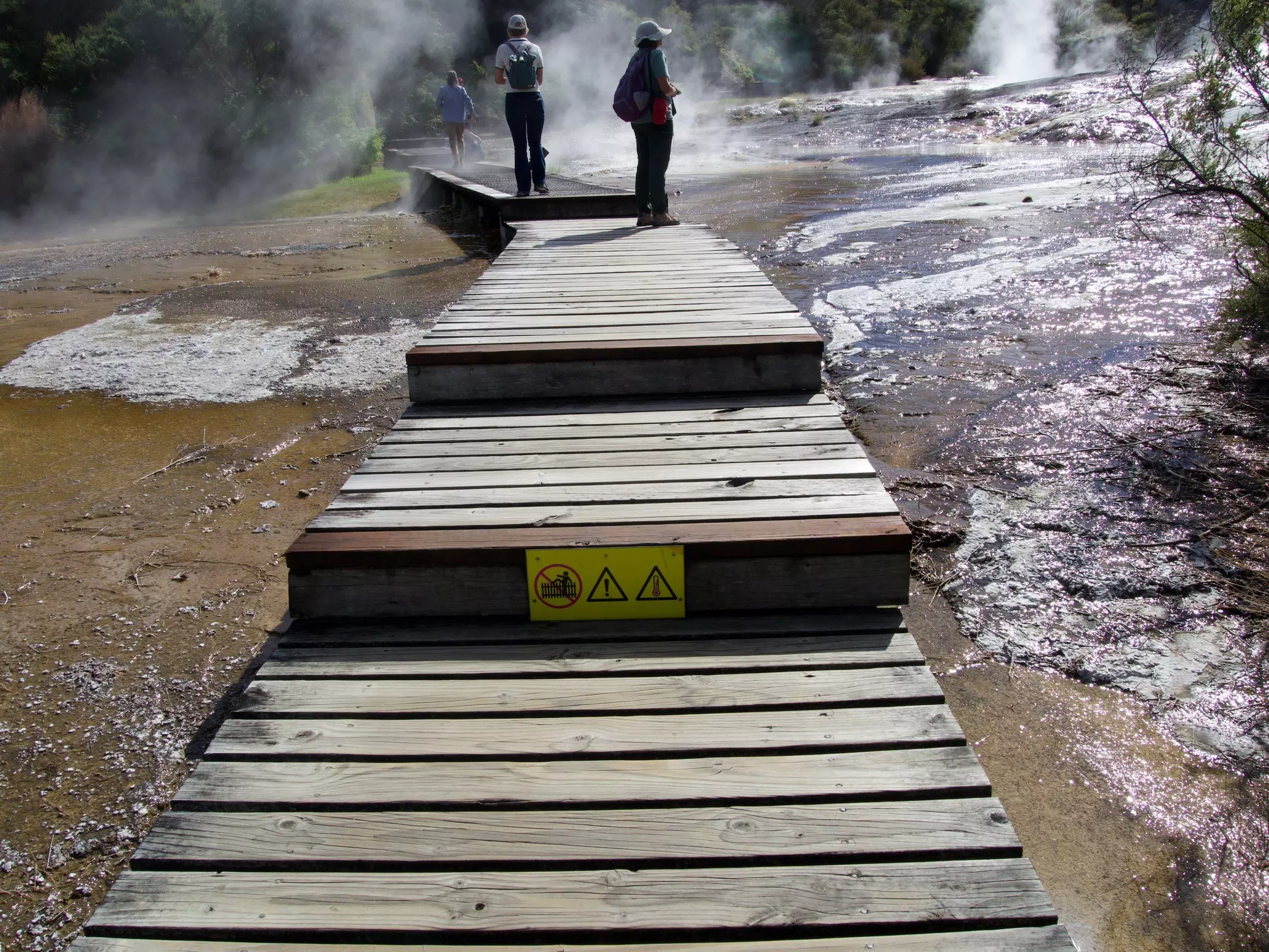 Walking the boardwalk through the hot springs at Orakei Korako Geothermal Park between Rotorua and Taupō in New Zealand (Aotearoa). 
