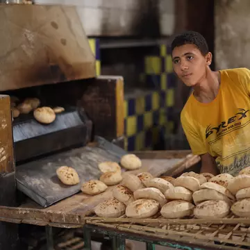 CAIRO, EGYPT - NOVEMBER 30, 2021: A young man works in a traditional bakery in Cairo, License Type: media, Download Time: 2025-11-10T11:23:43.000Z, User: joebindloss38, Editorial: true, purchase_order: 65050 - Digital Destinations and Articles, job: Online Editorial, client:  The best things to eat and drink in Egypt, other: Joe Bindloss
