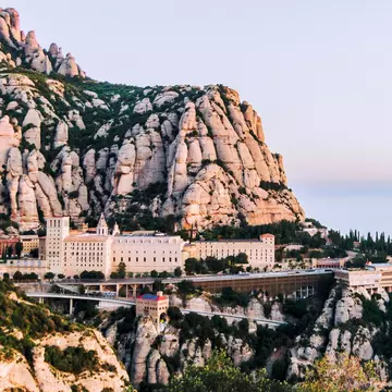 Montserrat, Spain - April 20, 2022:  View of Monserrat Monastery in the Mountains of Catalonia seen with visitors.
