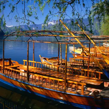 Gondolas, known locally as pletna, on the shores of Lake Bled. These pletna ferry passengers to Bled Island, which sits in the middle of the lake.