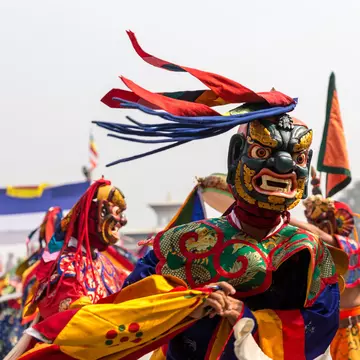 A Buddhist monk practices a traditional mask dance. ryosho/Shutterstock 