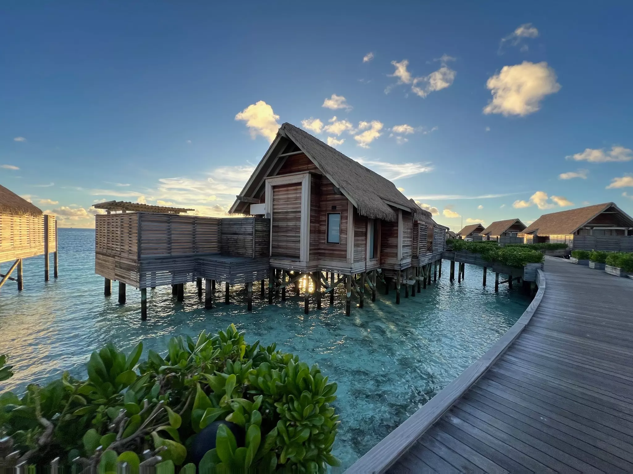 Overwater villas on along a wooden walkway