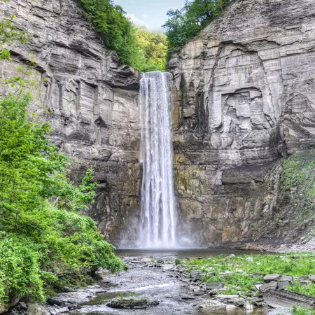 A tall waterfall against a rock cliff in New York.
