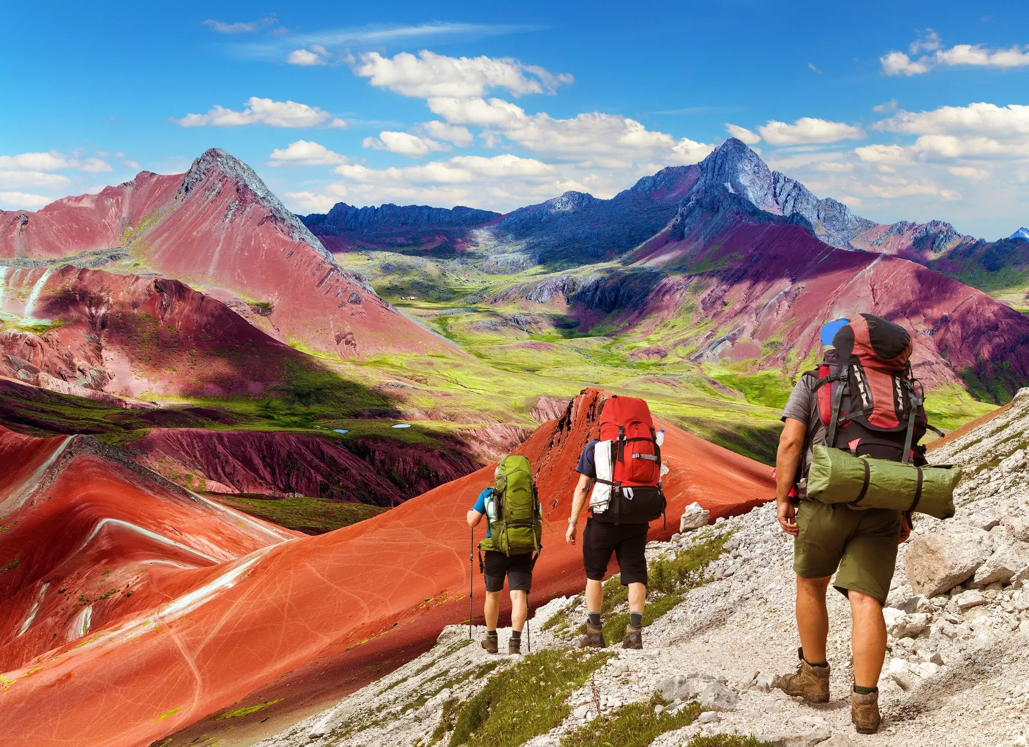 Rainbow mountains or Vinicunca Montana de Siete Colores with three tourists or hikers, Cuzco region in Peru, Peruvian Andes, License Type: media, Download Time: 2026-05-21T16:57:40.000Z, User: lonelyplanetmedia, Editorial: false, purchase_order: 65050 - Digital Destinations and Articles, job: Comp Ingestion, client: Global Publishing WIP, other: Pia Peterson