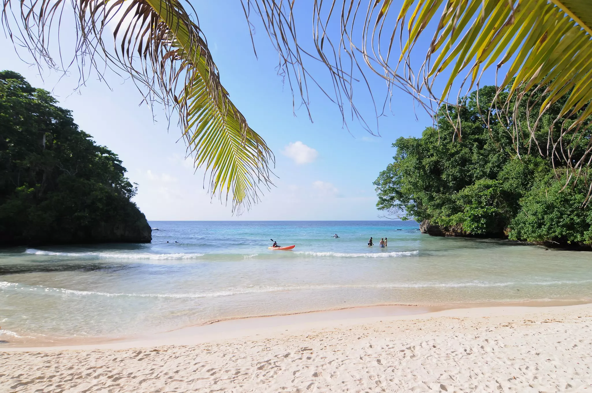 Beautiful view on Frenchman's Cove Beach with some tourists enjoying the water near Port Antonio, Jamaica