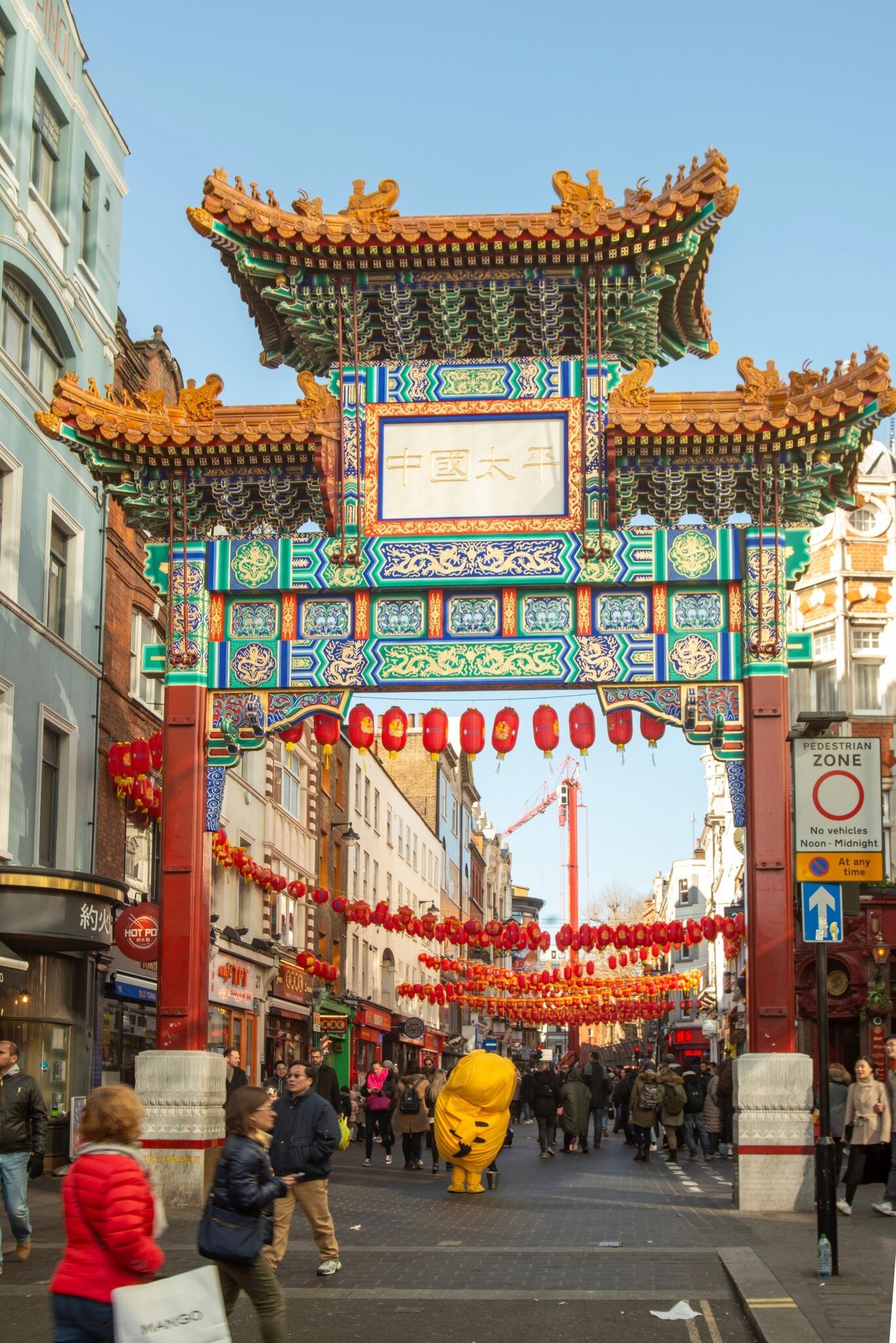View of the Chinatown Gate and Chinese New Year's decorations in Chinatown in London, UK.