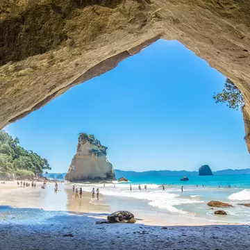Coromandel,New Zealand - January 24, 2016: Cathedral Cove in Coromandel Peninsula on the North Island of New Zealand. People can seen exploring around it.