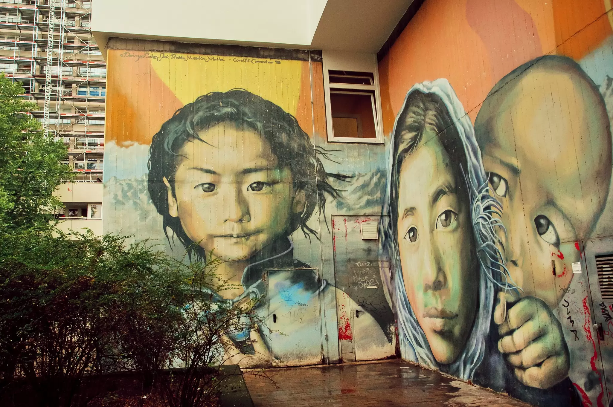 A 2015 street mural in Berlin depicting a refugee family