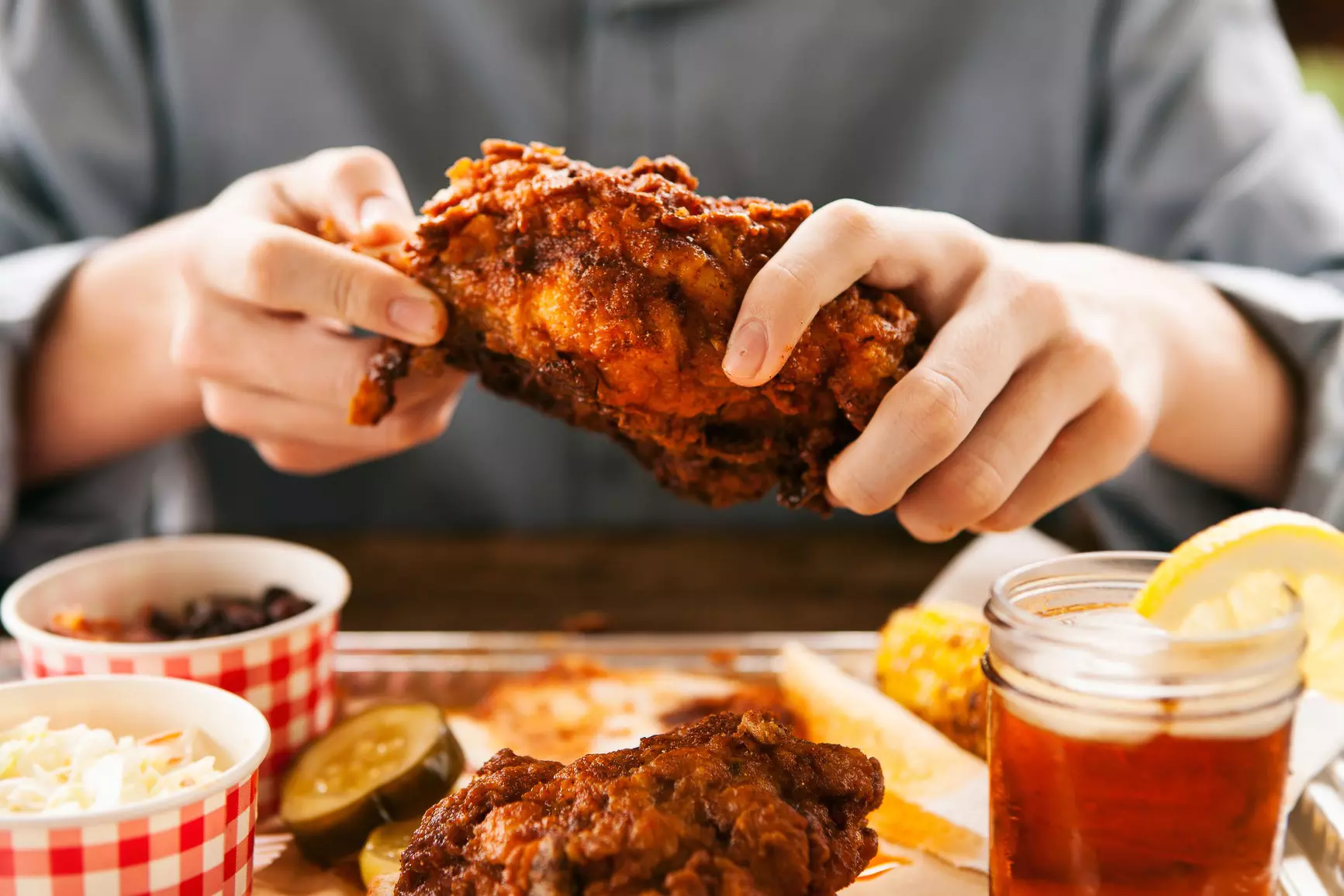 Man Digging into Hot Chicken Meal